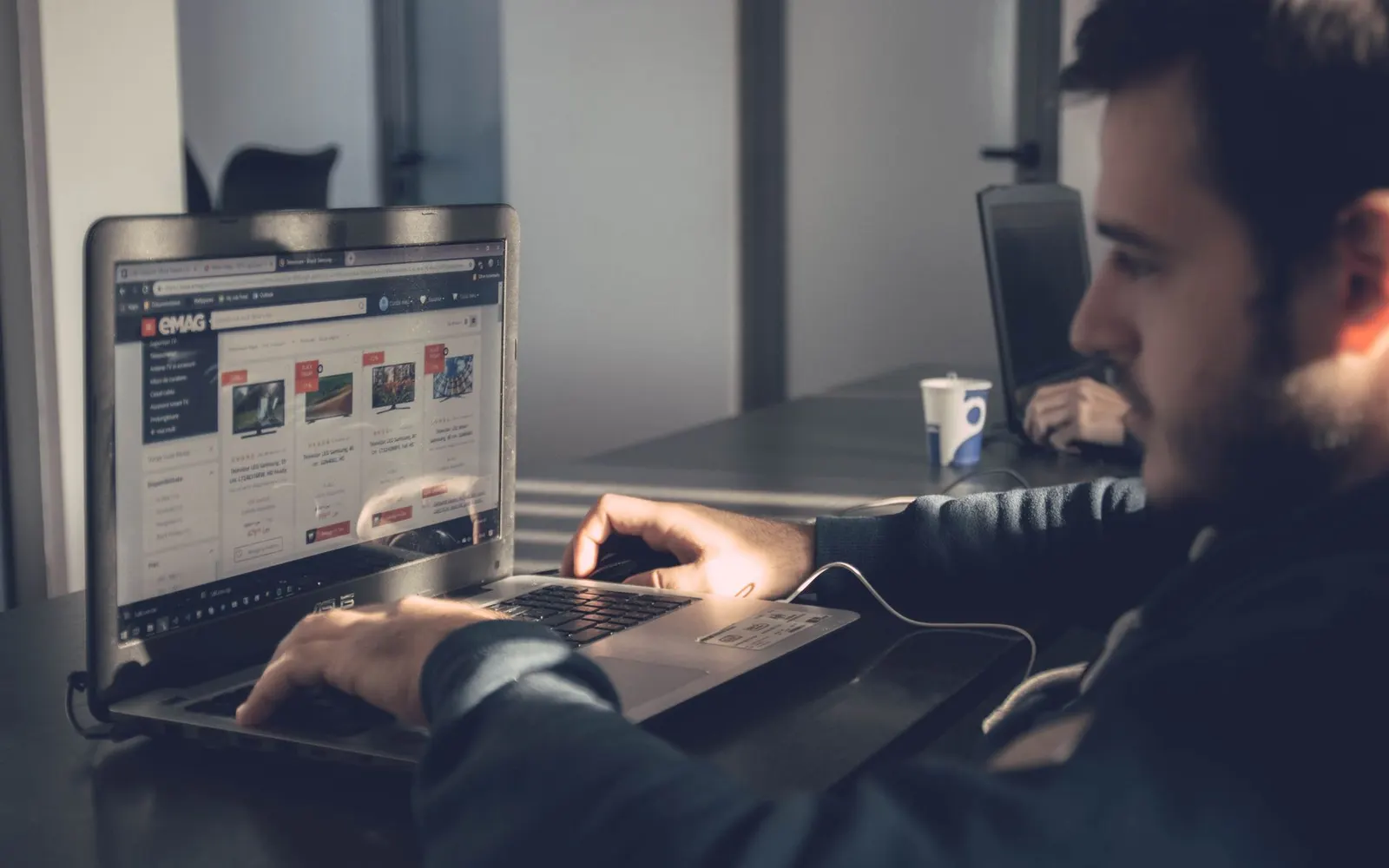 A person happily using a laptop to update their website