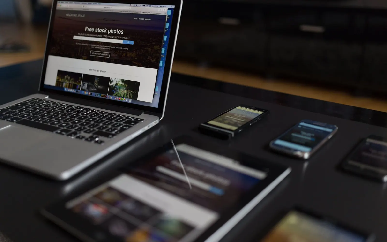 A designer's desk with a notebook, pen, and phone — planning a website