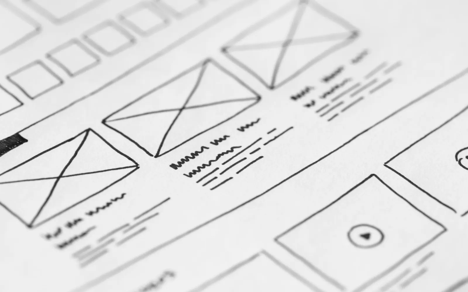Wireframe sketches and planning notes on paper