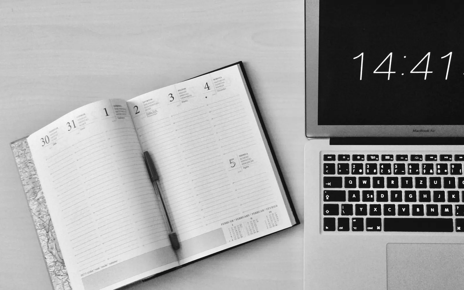 A calendar and clock on a desk, planning a project timeline