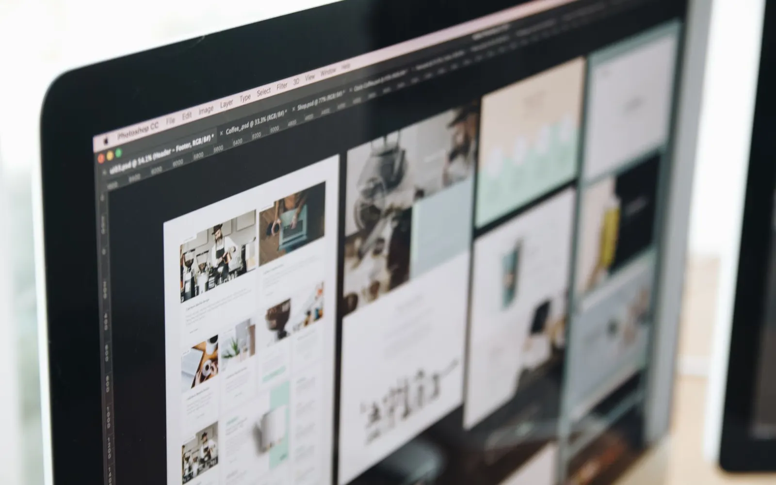Website layouts being designed on a computer screen
