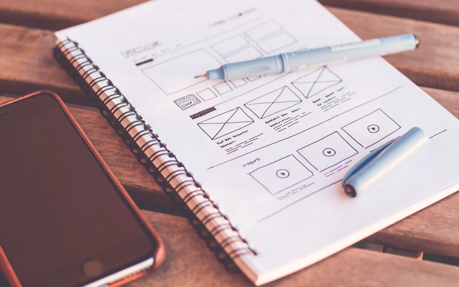 UX designer sketching interface wireframes on paper